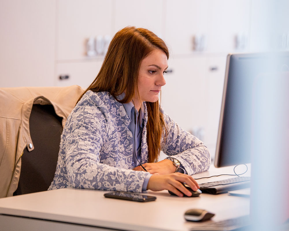 Infor team member focussed on computer